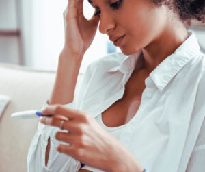 woman reading pregnancy test