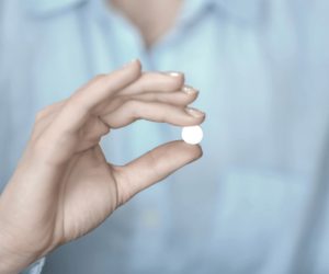 woman holding abortion pill